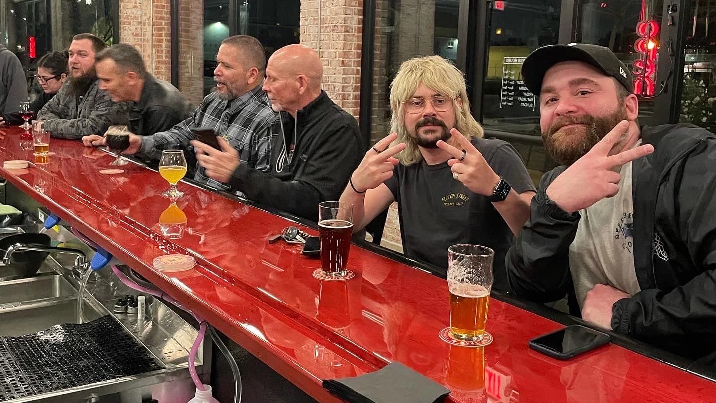 Patrons enjoying pizza and beer at South of Shaw Beer Company in downtown Fresno