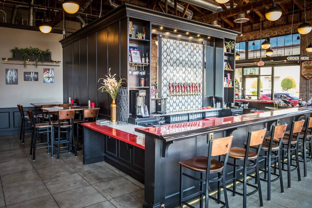 South of Shaw Beer Company taproom interior in downtown Fresno with craft beer taps and red bar top